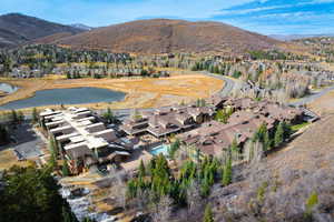 Birds eye view of property featuring a water and mountain view