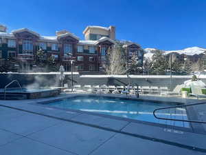 Snow covered pool with a mountain view