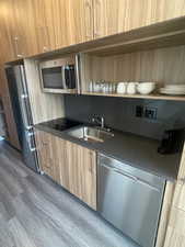 Kitchen with sink and appliances with stainless steel finishes