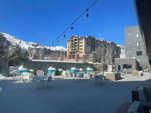 Snow covered patio featuring a mountain view and an outdoor living space