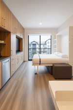 Living room with light wood-type flooring and recessed lighting