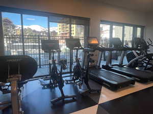 Exercise room with a mountain view and a healthy amount of sunlight