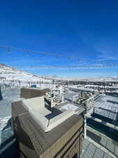 Snow covered deck featuring an outdoor hangout area