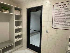 Bathroom featuring tile patterned flooring and tile walls