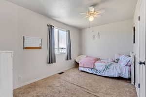 Bedroom featuring carpet flooring and ceiling fan