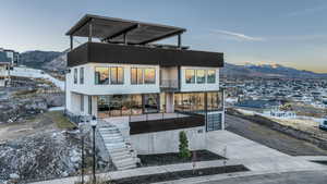 View of front of property with a mountain view and a balcony