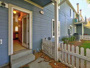 Doorway to property featuring central AC