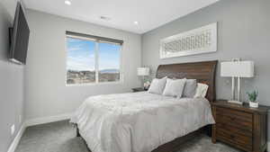 Bedroom with dark colored carpet