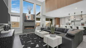 Living room with a tile fireplace and a towering ceiling