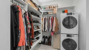 Washroom with stacked washer and clothes dryer