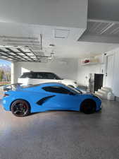 Garage featuring stainless steel refrigerator