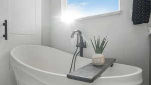 Bathroom with a bathing tub and plenty of natural light