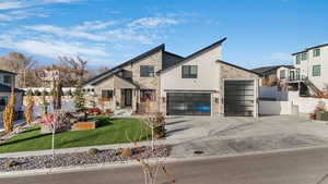 View of front of house featuring a front yard and a garage