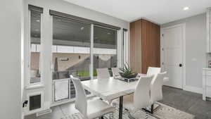 Dining space with dark tile patterned floors