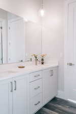 Bathroom featuring hardwood / wood-style flooring and vanity