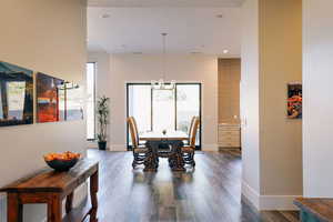 Dining room featuring hardwood / wood-style floors and a chandelier