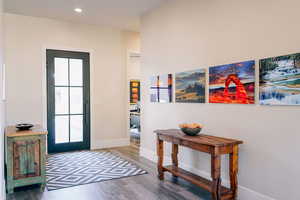 Doorway featuring wood-type flooring