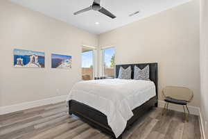 Bedroom with ceiling fan and hardwood / wood-style flooring