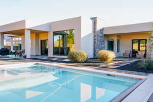 View of swimming pool featuring an in ground hot tub and a patio