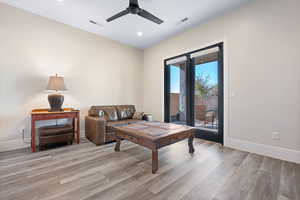 Living room featuring ceiling fan and light hardwood / wood-style floors