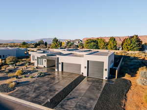 View of front of house with a mountain view and a garage