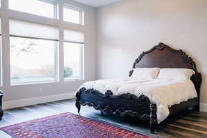 Bedroom featuring hardwood / wood-style floors and multiple windows