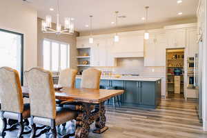 Dining room featuring a chandelier and light hardwood / wood-style flooring