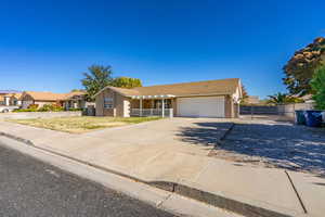 Single story home with covered porch and a garage