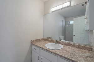 Bathroom featuring vanity and toilet