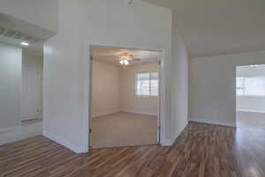 Empty room featuring ceiling fan and dark hardwood / wood-style flooring