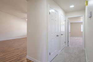 Hall with hardwood / wood-style floors and a textured ceiling