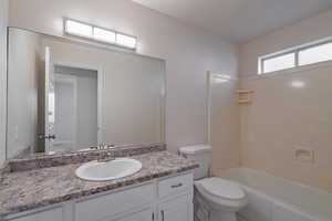 Full bathroom featuring shower / washtub combination, vanity, and toilet