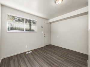 Unfurnished room with dark hardwood / wood-style flooring