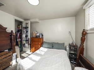 Carpeted bedroom featuring a closet