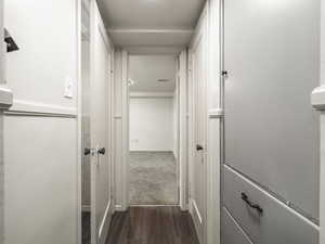 Hall with dark hardwood / wood-style floors