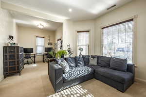 Carpeted living room with plenty of natural light