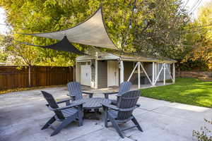 View of patio with an outdoor structure and a garage