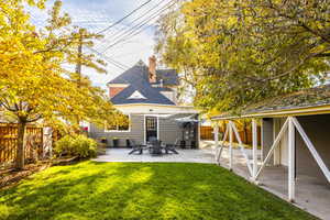 Rear view of property featuring a patio and a lawn