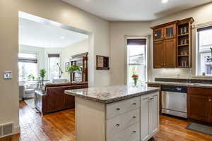 Kitchen with a wealth of natural light, white cabinetry, and dishwasher