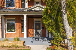 View of exterior entry featuring a porch