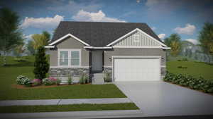 View of front of home with a garage and a front yard