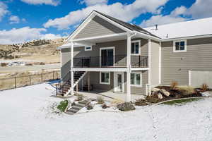 Snow covered property featuring central air condition unit