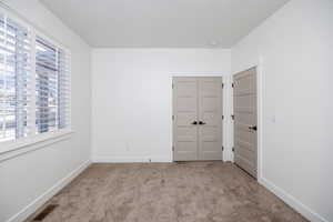 Carpeted empty room with plenty of natural light