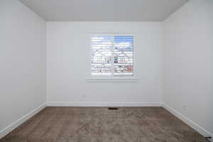 View of medium colored carpeted empty room