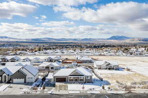 Snowy aerial view featuring a mountain view