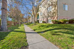 View of home's community with a yard