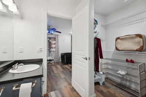 Bathroom featuring ceiling fan, hardwood / wood-style floors, and vanity