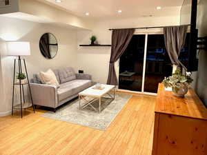 Living room with light hardwood / wood-style floors