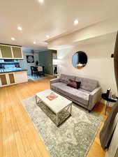 Living room with hardwood / wood-style flooring and ceiling fan