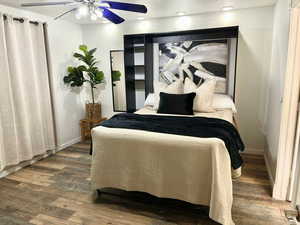 Bedroom with ceiling fan and dark hardwood / wood-style flooring